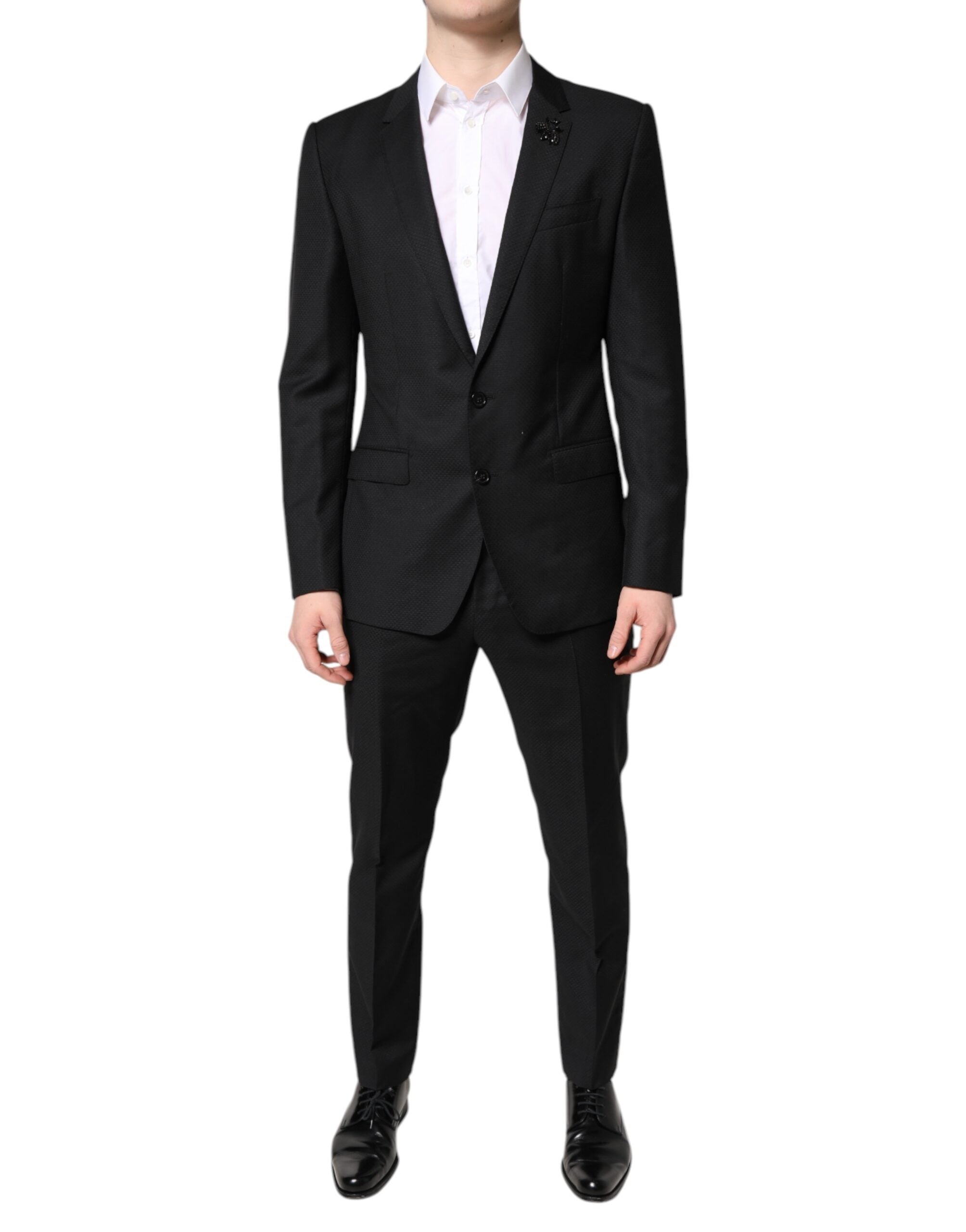Costume homme Dolce & Gabbana en laine noire à deux pièces, veste croisée simple boutonnage et pantalon assorti.