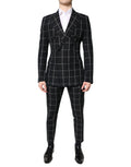 Costume deux pièces noir Dolce & Gabbana Taormina avec veste à double boutonnage et pantalon assorti, élégant et classique.