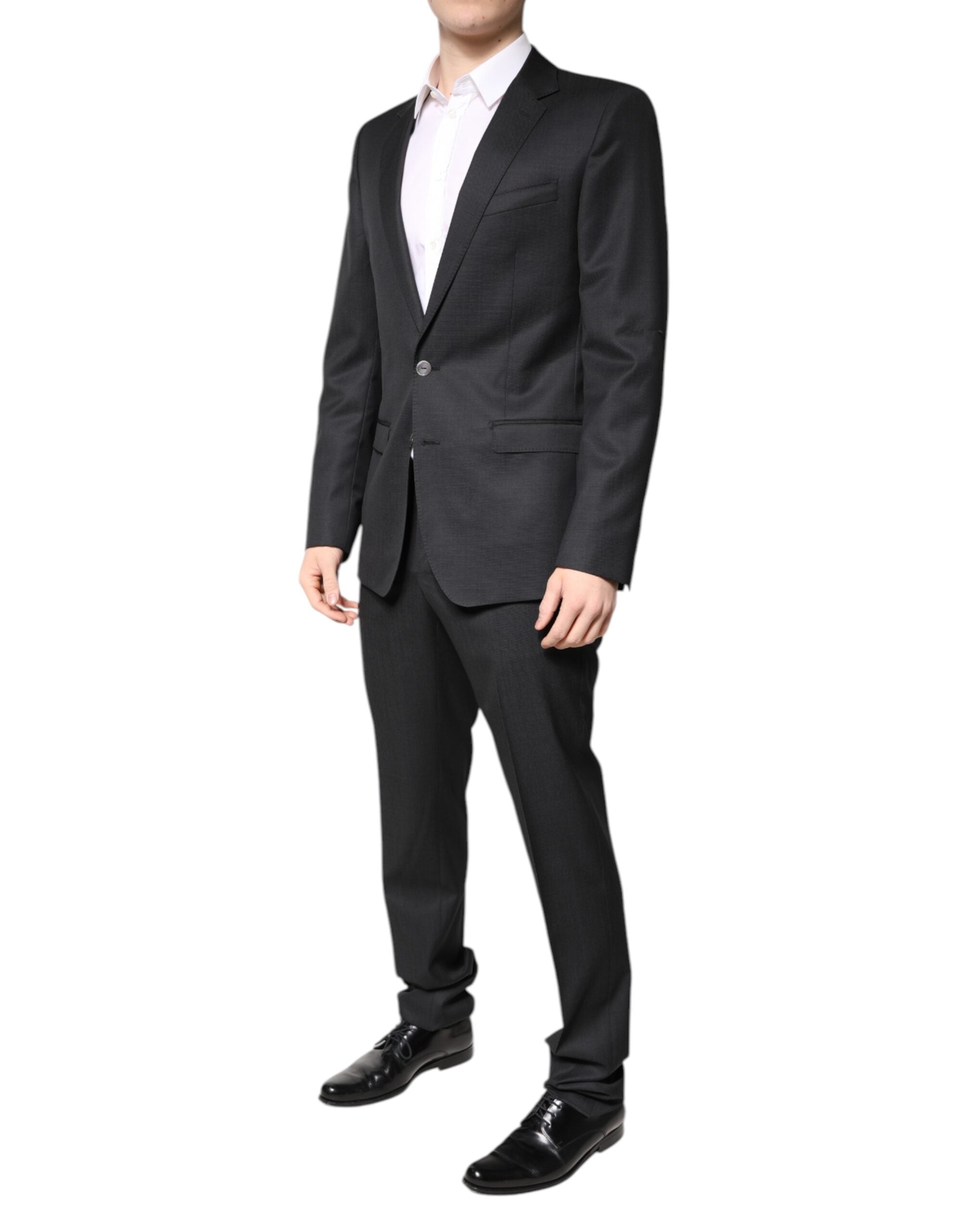 Costume homme Dolce & Gabbana en laine gris foncé à deux pièces, veste croisée simple et pantalon assorti.