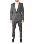 Costume en laine gris à deux boutons Dolce & Gabbana, costume deux pièces à revers simple et coupe élégante.