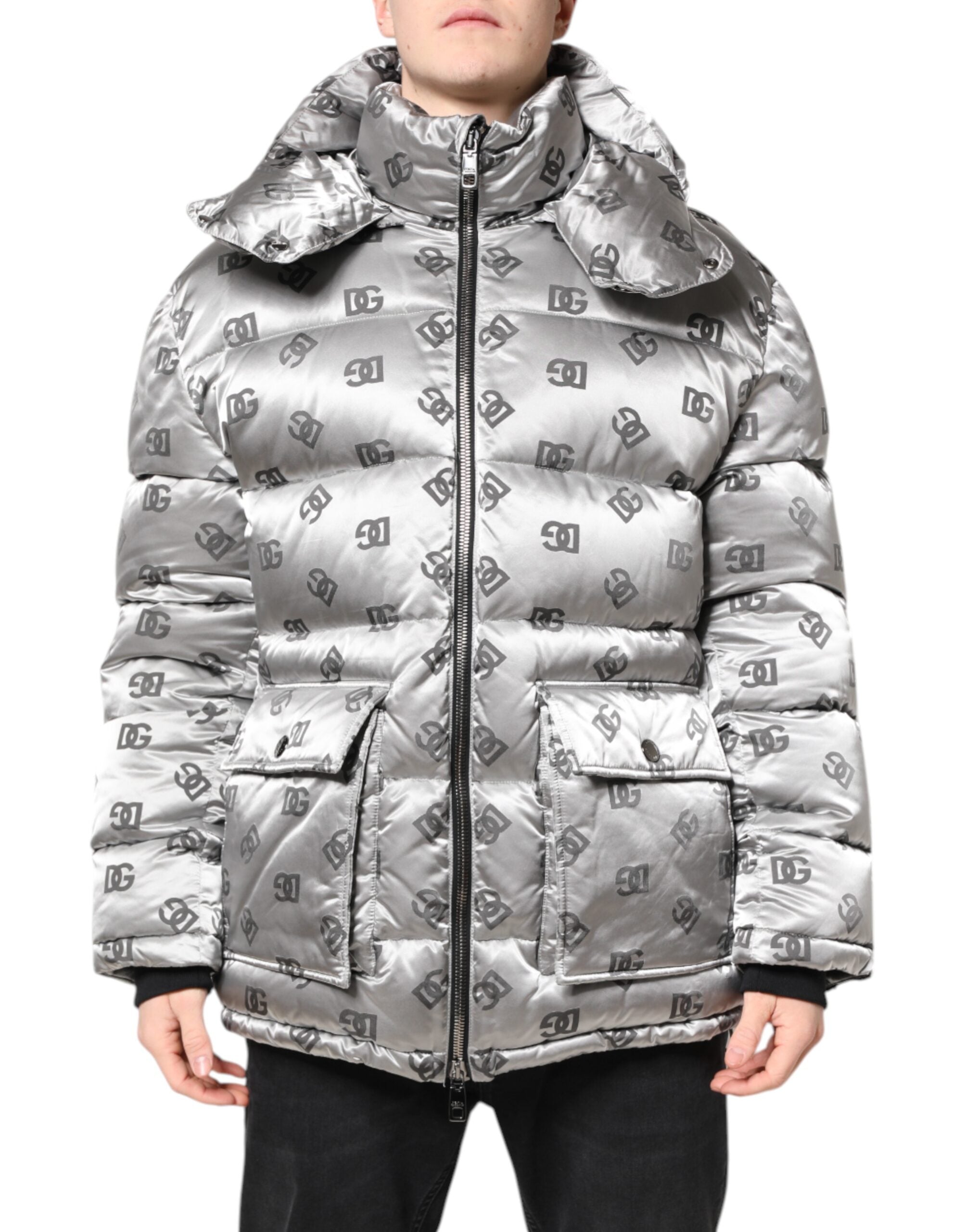 Veste matelassée zippée à capuche Dolce & Gabbana avec logo argenté visible, élégante et chaude, en tissu brillant argenté.