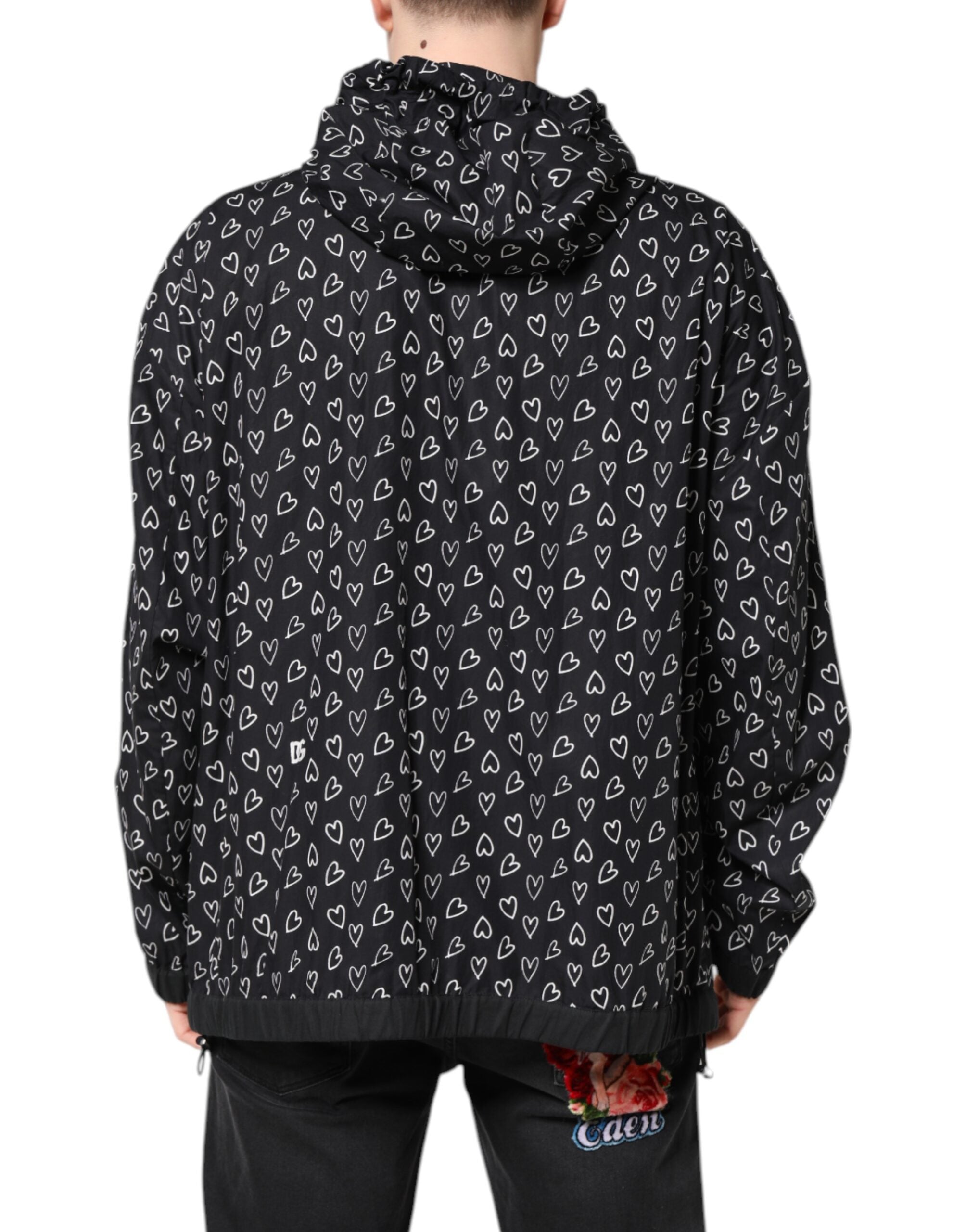 Veste coupe-vent noire Dolce & Gabbana avec motif cœur imprimé, capuche et style décontracté.