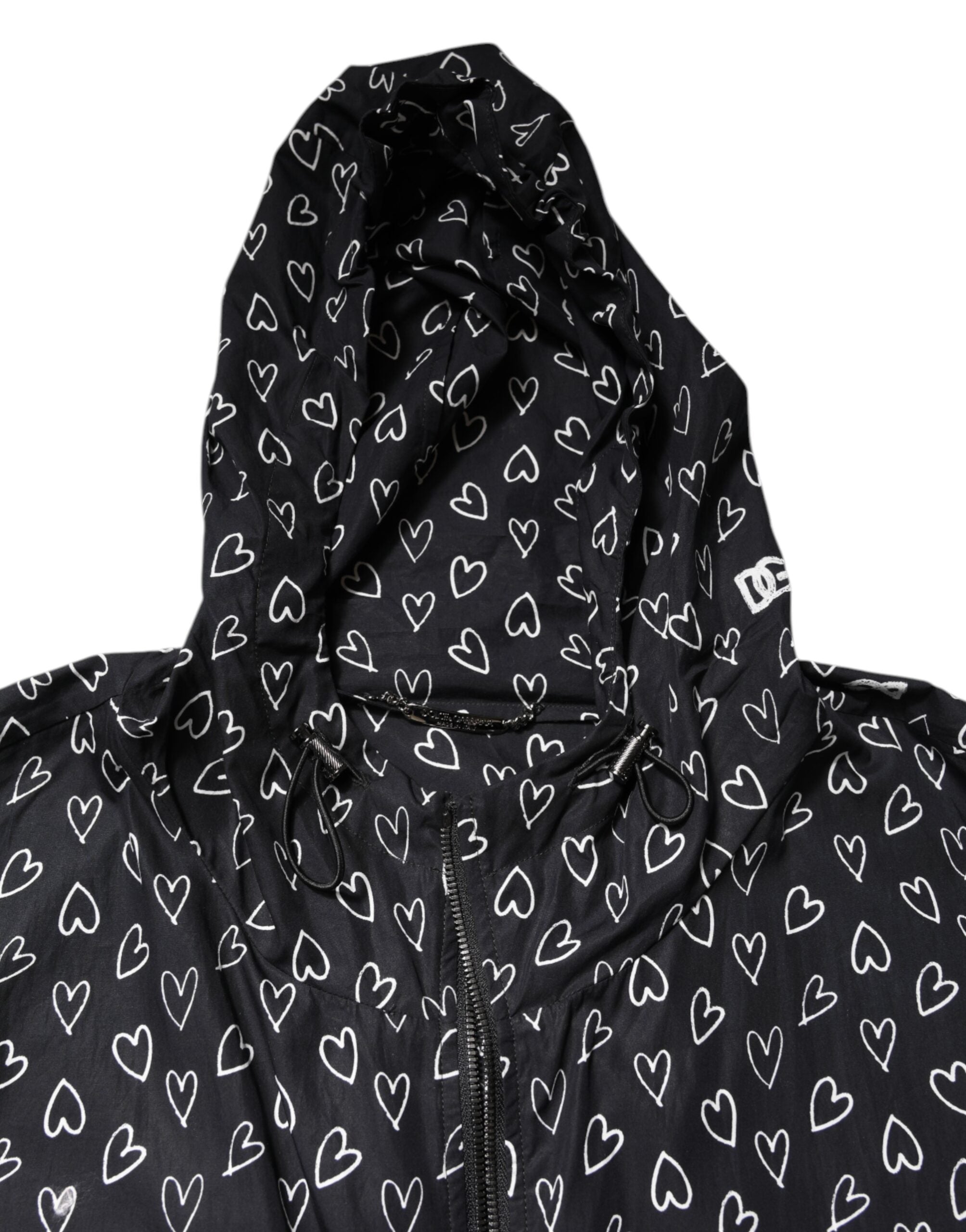 Veste coupe-vent noire Dolce & Gabbana avec motif cœur imprimé, capuche et style décontracté.