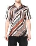 Chemise à manches courtes en soie à rayures multicolores de Dolce & Gabbana, tissu élégant et coloré visible sur l'image.