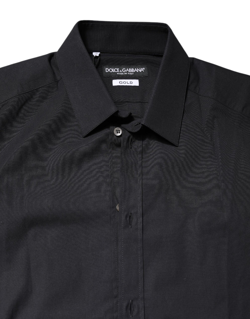 Chemise longue en coton noir et or Dolce & Gabbana avec manches longues, détails élégants, adaptée pour un look sophistiqué.