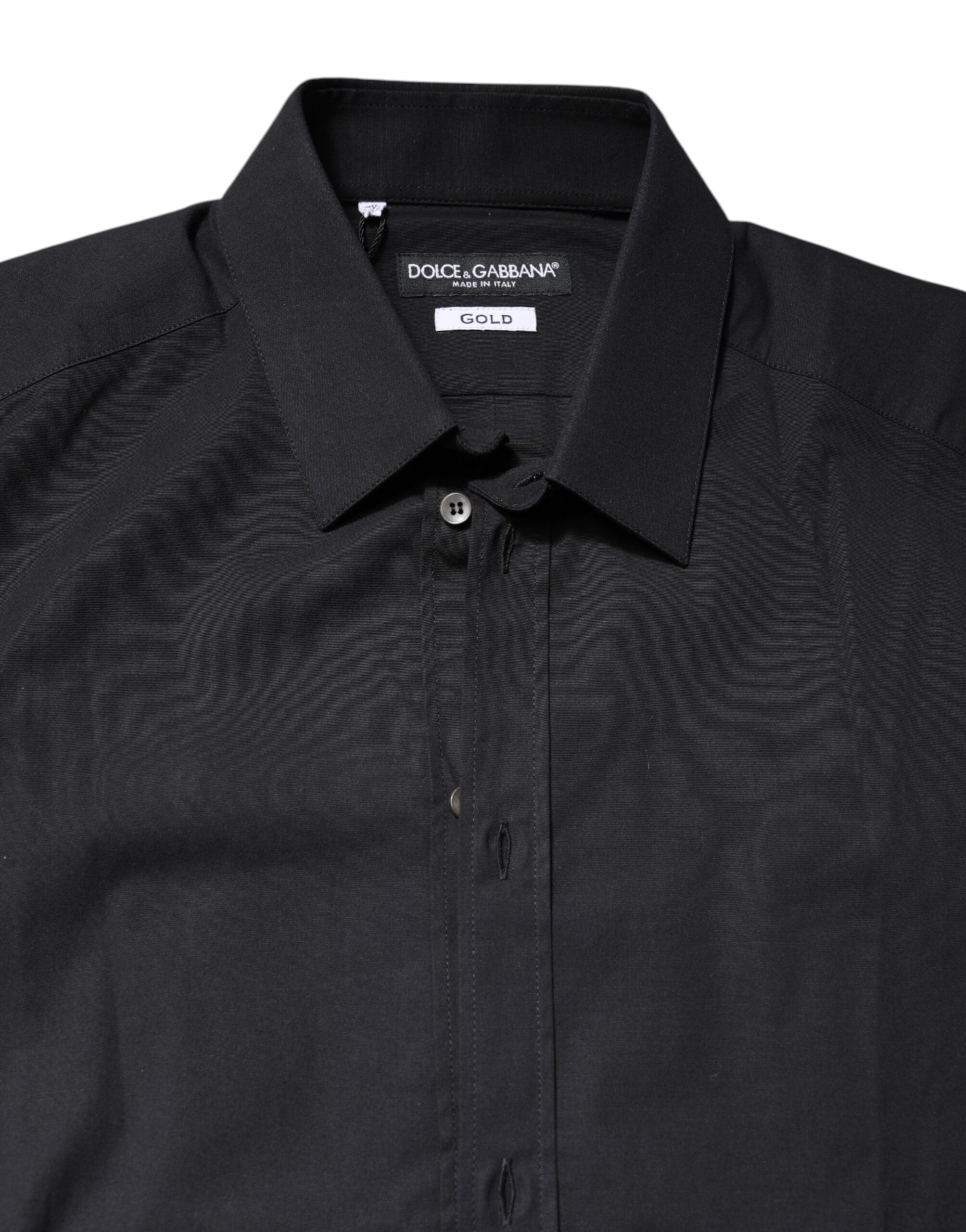 Chemise longue en coton noir et or Dolce & Gabbana avec manches longues, détails élégants, adaptée pour un look sophistiqué.