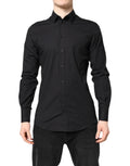 Chemise formelle noire en coton Dolce & Gabbana avec détails dorés, élégante et sophistiquée, vue de face.
