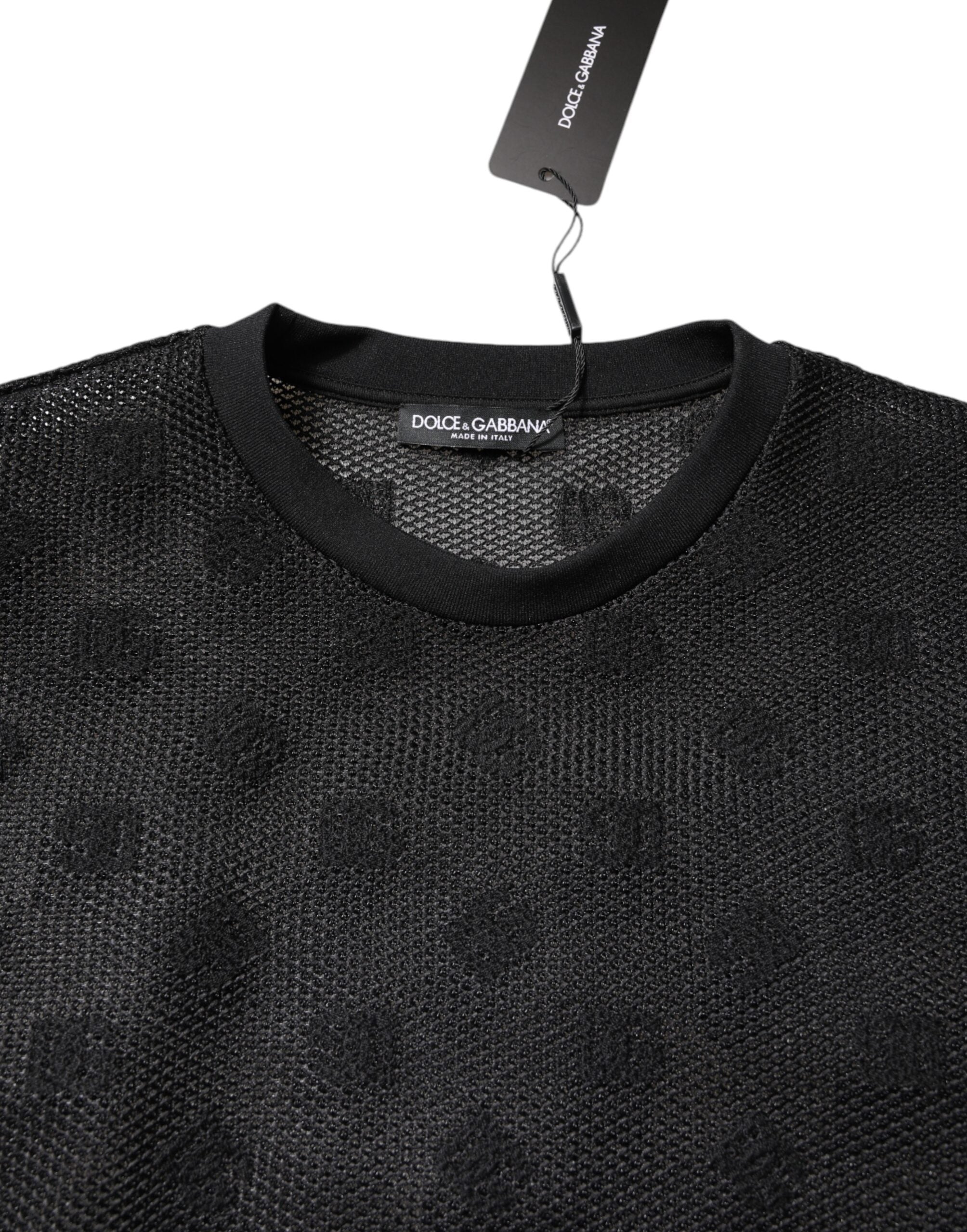 T-shirt noir Dolce & Gabbana à manches courtes en tissu transparent avec logo visible, élégante et tendance.