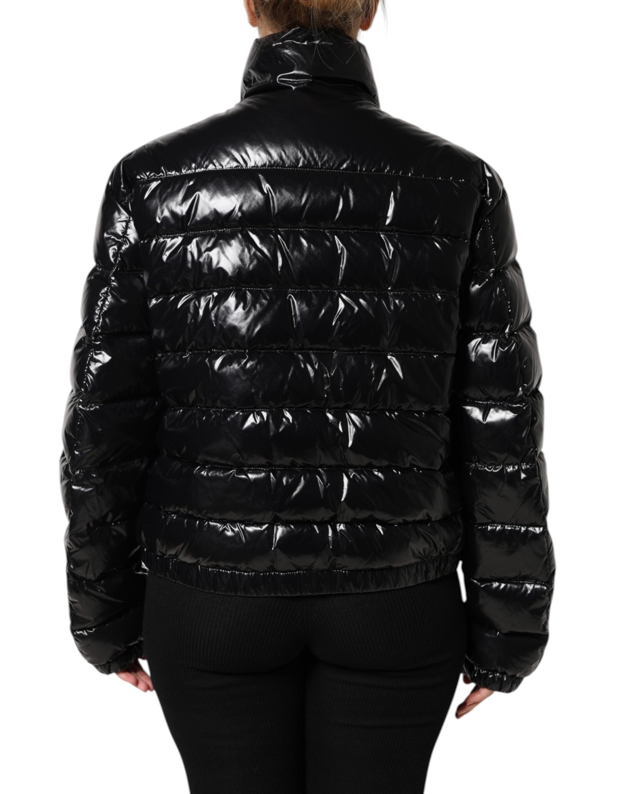 Veste matelassée noire Dolce & Gabbana avec logo en plaque, zippée complète, style chaud et tendance pour l'hiver.