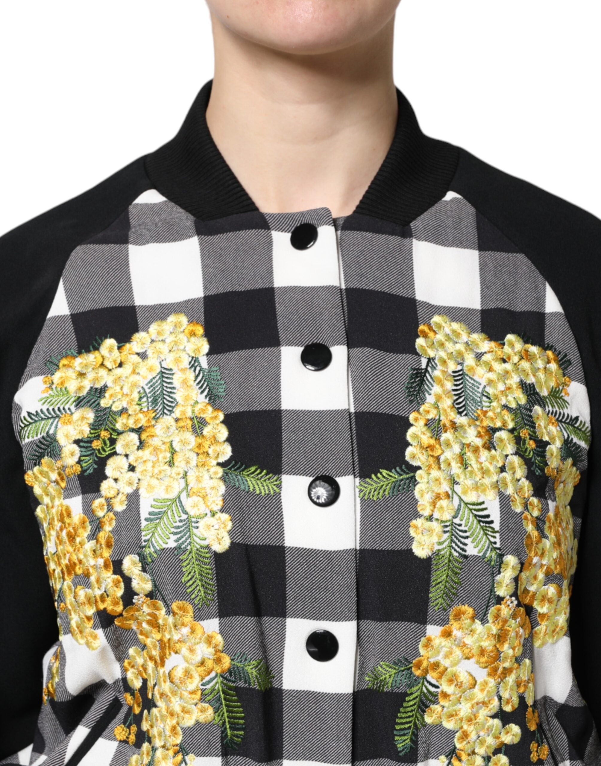 Veste à carreaux noir et blanc Dolce & Gabbana avec motifs floraux et boutons, style élégant et sophistiqué.
