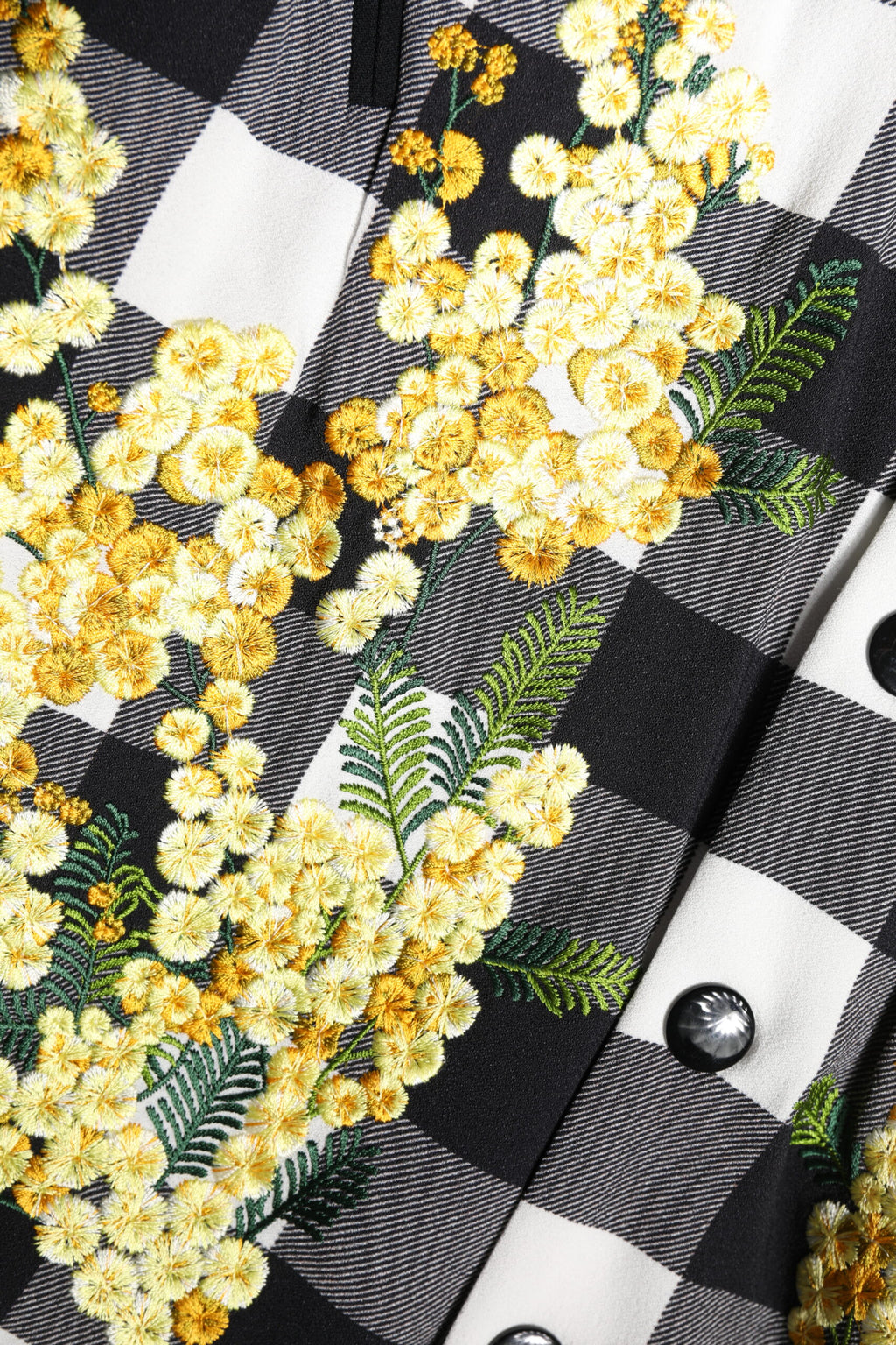 Veste à boutons Dolce & Gabbana à carreaux noir et blanc avec motif floral, style décontracté et élégant.
