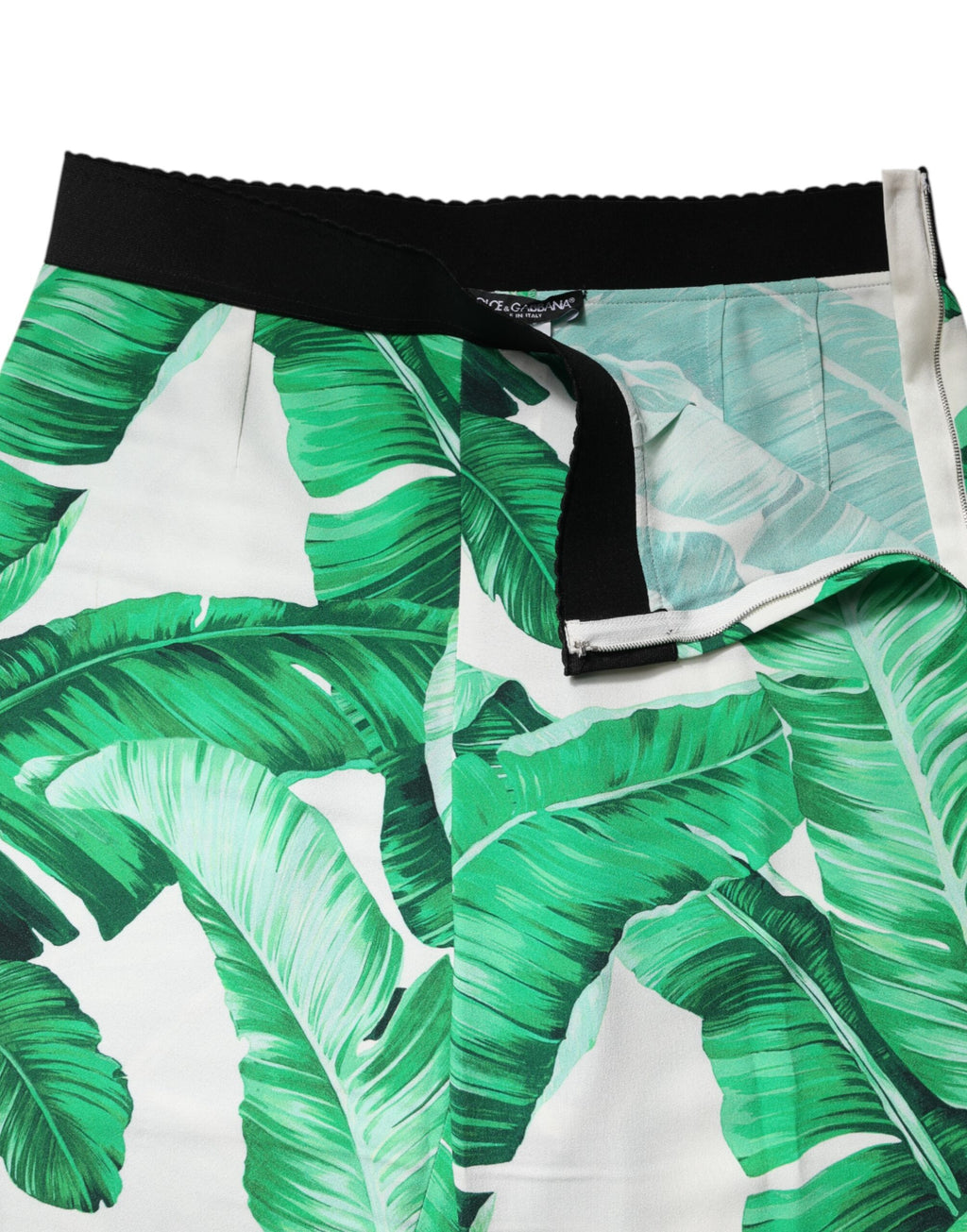 Pantalons taille haute Dolce & Gabbana blanc et vert avec motif de feuilles, mode élégante et sophistiquée.