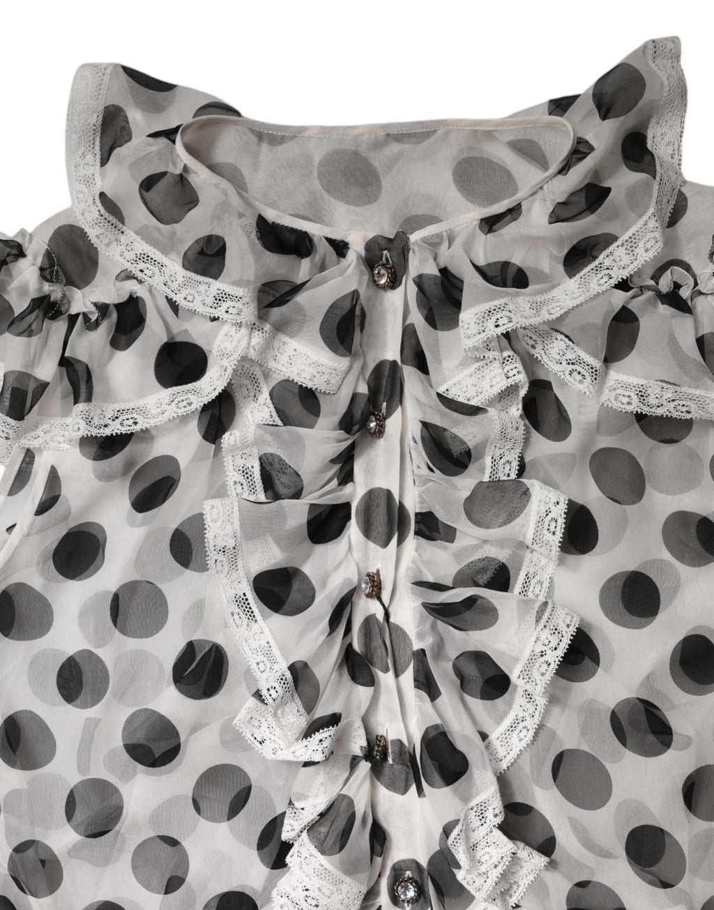 Haut sans manches en coton blanc et noir à pois de Dolce & Gabbana, style élégant et léger, visible dans l'image.