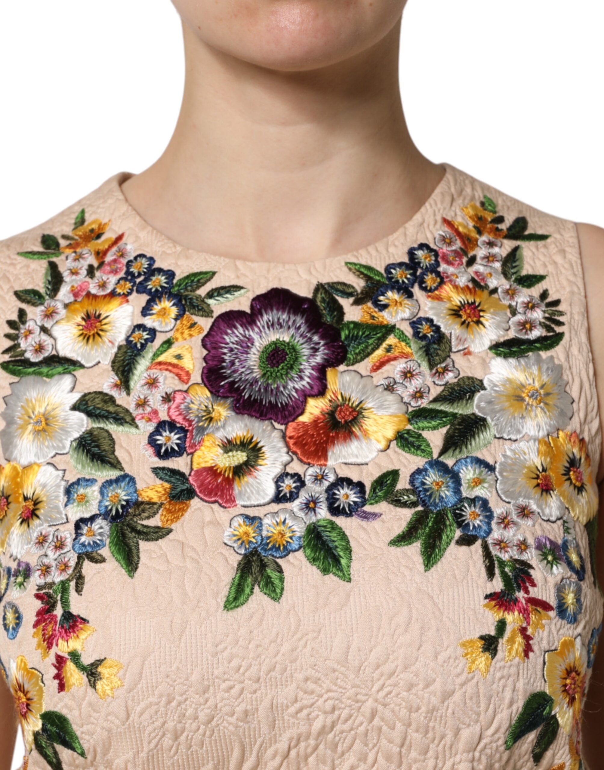 Top sans manches beige Dolce & Gabbana avec broderie florale élégante, parfait pour un style sophistiqué et féminin.