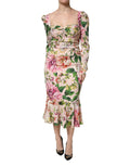 Robe midi en soie rose à fleurs Dolce & Gabbana, coupe ajustée et évasée, avec détails floraux élégants.
