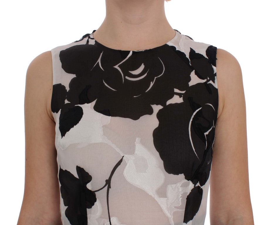 Robe de soirée Dolce & Gabbana en soie noire et blanche avec motif floral, coupe ajustée et élégante.