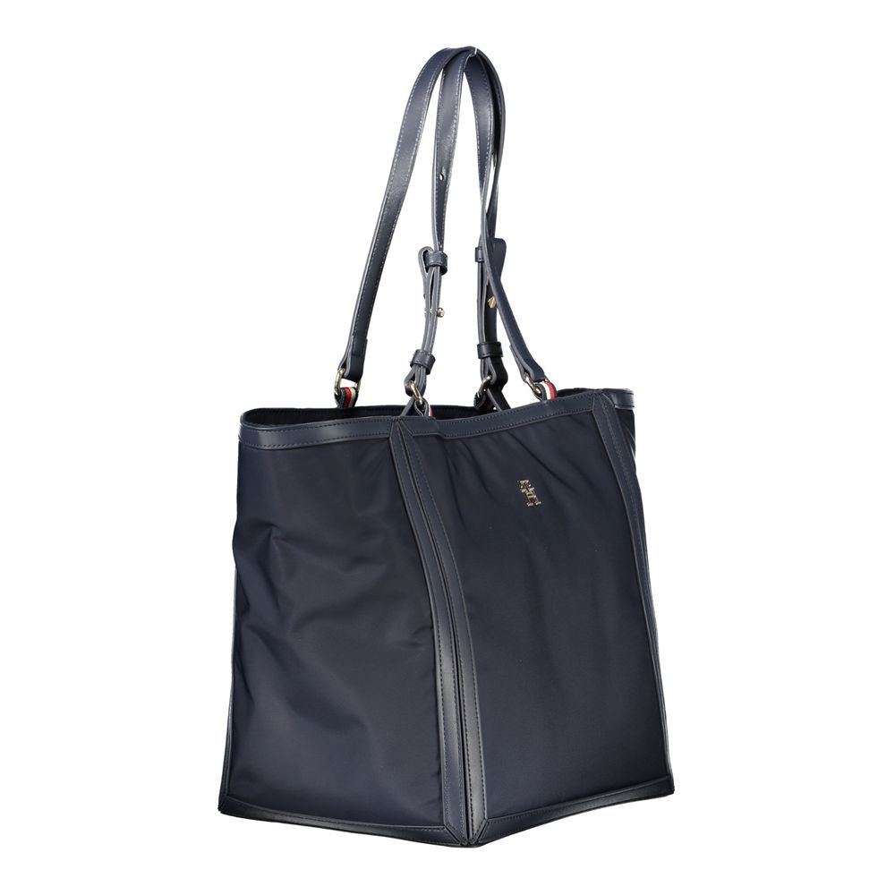 Sac à main en polyester bleu pour femme de la marque Tommy Hilfiger, visible avec poignées et détails élégants.