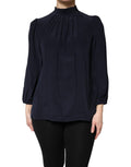 Chemise en soie bleue Dolce & Gabbana à col montant et manches longues, élégante et sophistiquée.