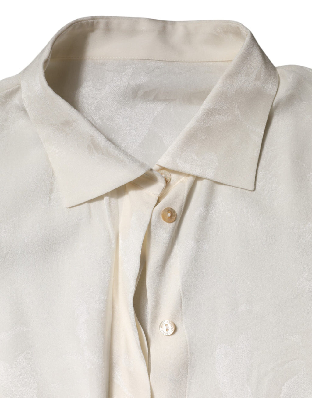 Chemise blanche à manches longues Dolce & Gabbana, boutonnière élégante, tissu léger et sophistiqué.