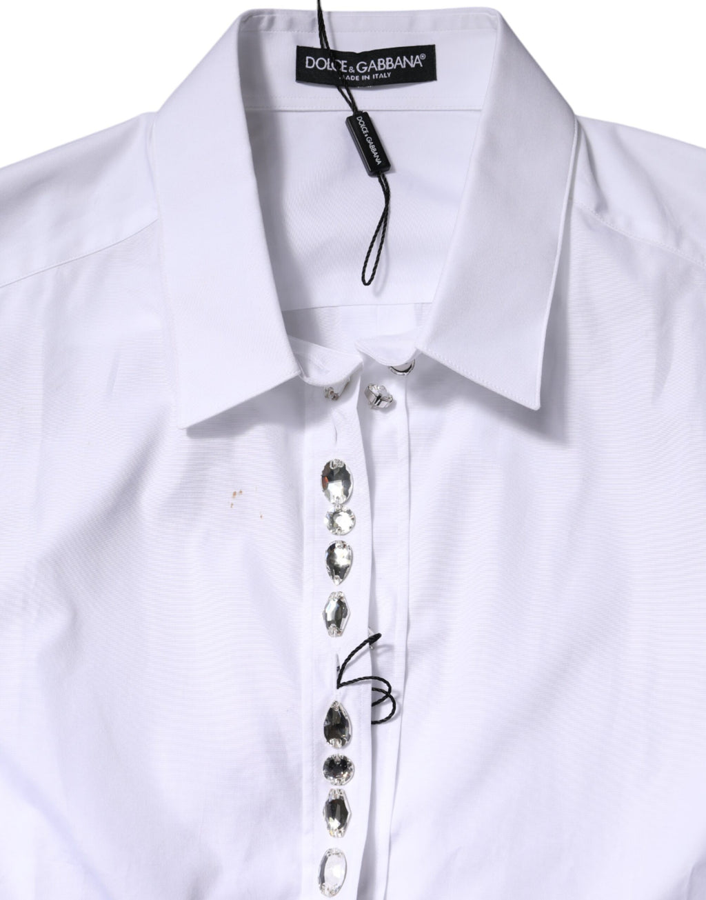 Top blanc Dolce & Gabbana à manches longues avec strass ornés et détails élégants, tissu léger et sophistiqué.