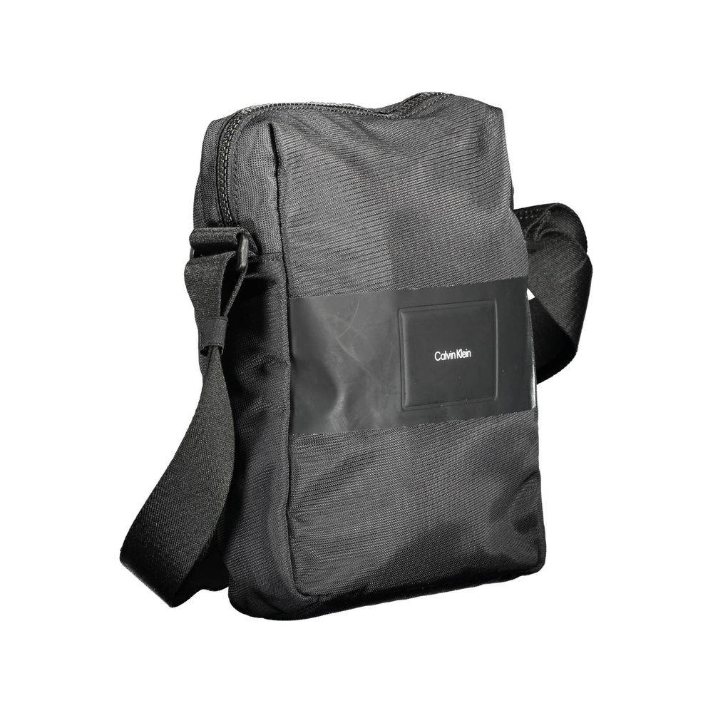 Sac à bandoulière pour homme Calvin Klein en polyester noir, avec compartiments et logo visible sur le devant.