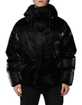 Veste matelassée noire Dolce & Gabbana à capuche avec logo, fermeture éclair intégrale, design élégant et moderne.