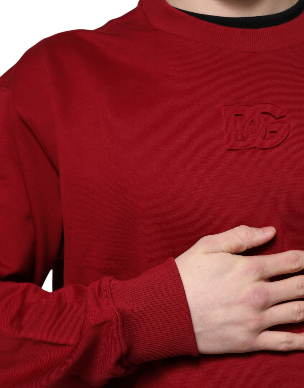 Pull en coton rouge Dolce & Gabbana avec logo embossé, col rond, détail élégant visible sur l'image.