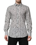 Chemise longue à manches longues Dolce & Gabbana blanche avec imprimé floral, style décontracté et élégant.
