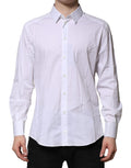 Chemise longue blanche en coton Dolce & Gabbana avec manches longues et détails dorés visibles sur l'image.