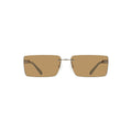 Lunettes de soleil pour femmes de Calvin Klein, monture en métal beige, style élégant et moderne.