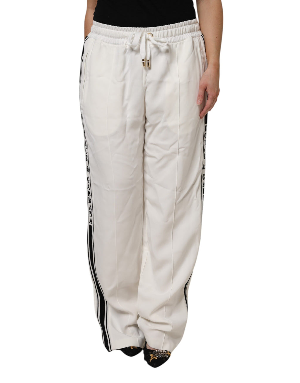 Pantalon jogger blanc Dolce & Gabbana en coton avec ceinture élastique et poches latérales, style confortable et tendance.