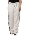 Pantalon jogger blanc Dolce & Gabbana en coton avec ceinture élastique et poches latérales, style confortable et tendance.