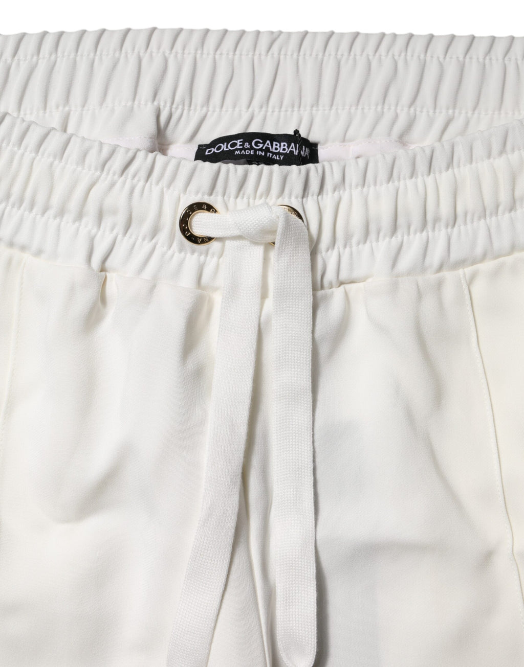 Pantalon de jogging blanc Dolce & Gabbana en coton avec ceinture élastique et poches latérales, style décontracté et élégant.