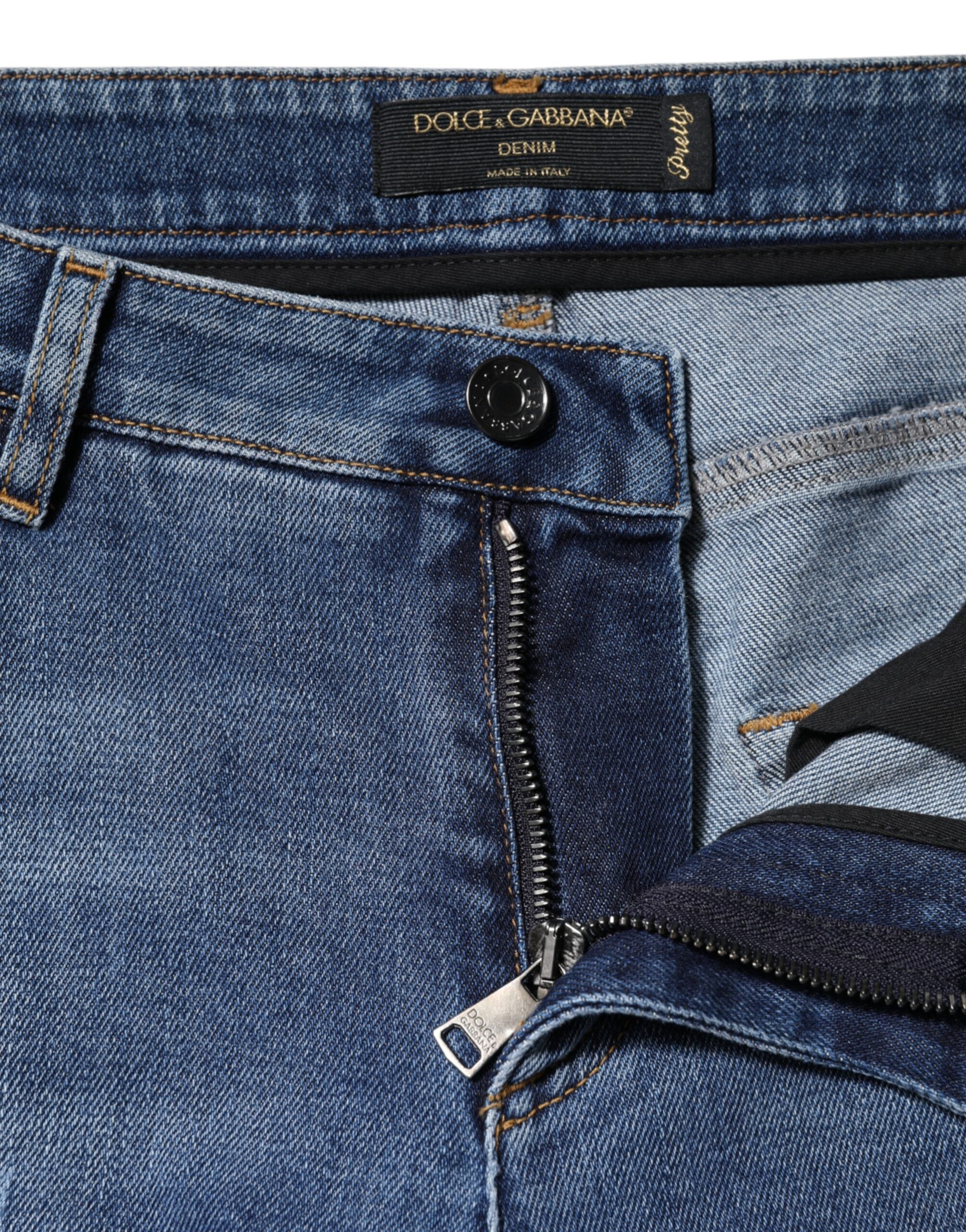 Jeans en denim bleu déchiré à taille basse de Dolce & Gabbana, coupe décontractée et style tendance.
