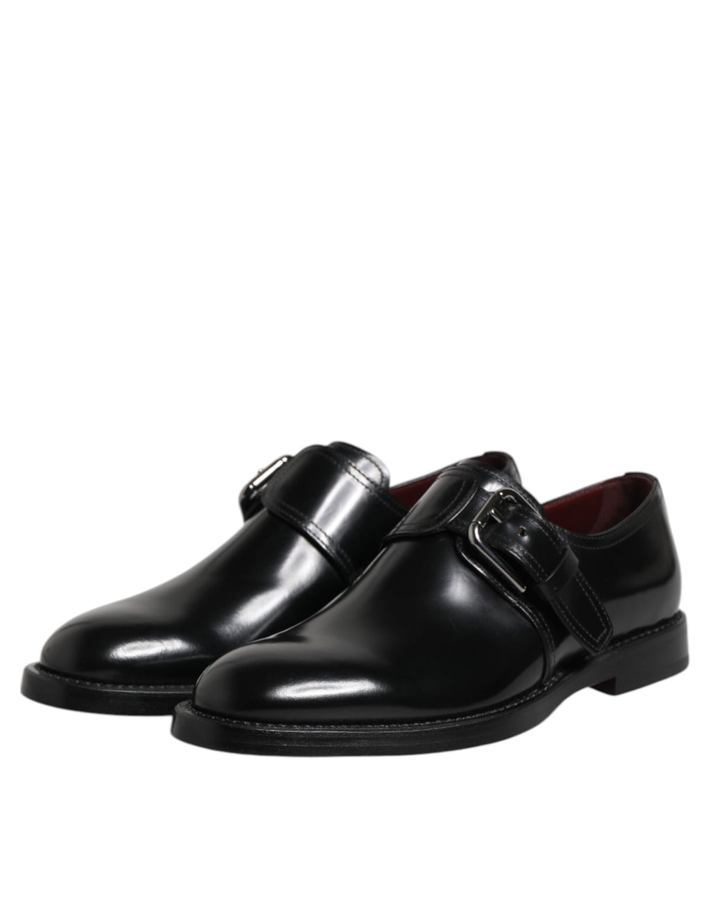 Chaussures derby formelles en cuir noir Dolce & Gabbana avec bride monk, élégantes et sophistiquées, vues de face sur fond blanc.