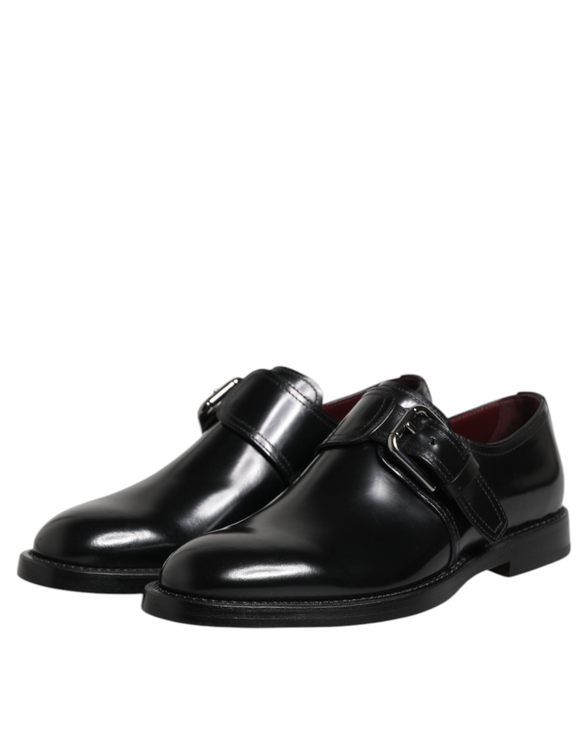 Chaussures derby formelles en cuir noir Dolce & Gabbana avec bride monk, élégantes et sophistiquées, vues de face sur fond blanc.