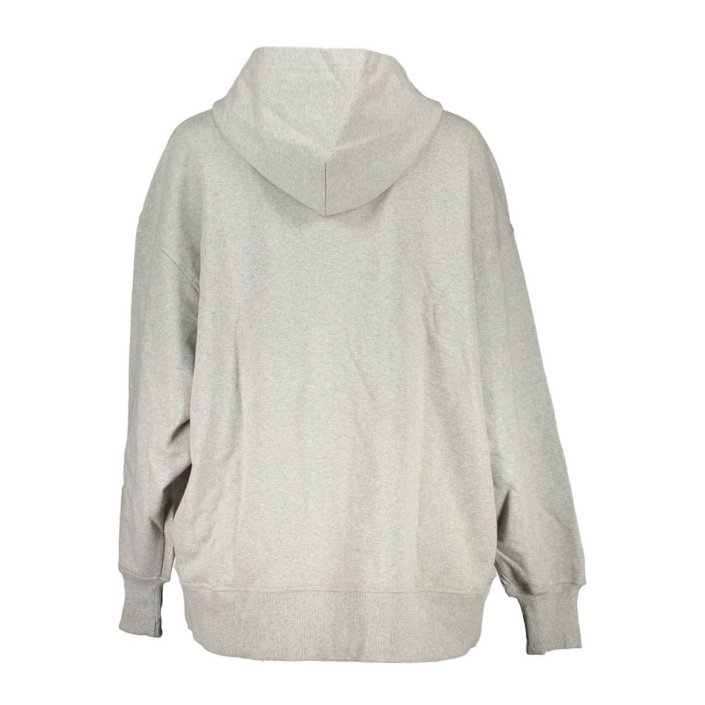 Sweat-shirt Calvin Klein Donna en coton recyclé gris, avec logo discret, porté sur un fond neutre.