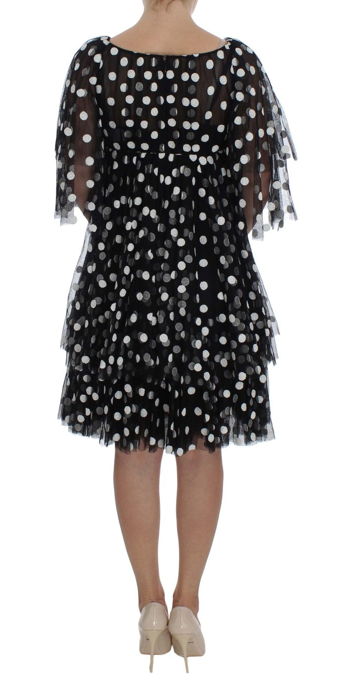 Robe à pois noire et blanche Dolce & Gabbana avec volants, style élégant et tissu fluide, vue de face.