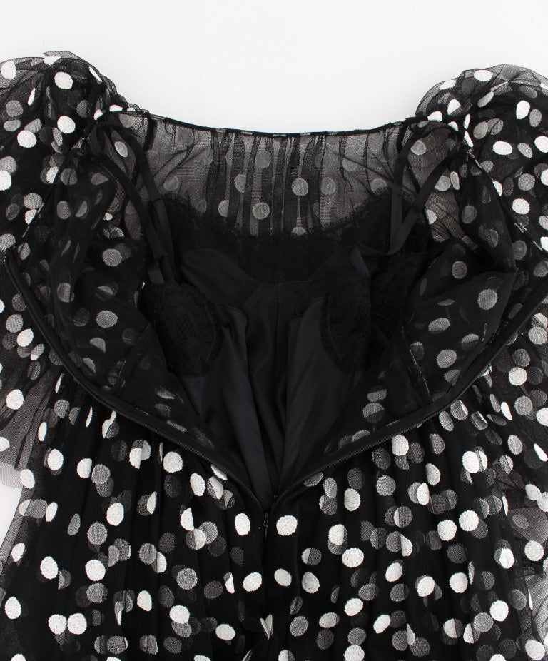 Robe à pois noir et blanc Dolce & Gabbana avec volants, style élégant et féminin, tissu léger et fluide.