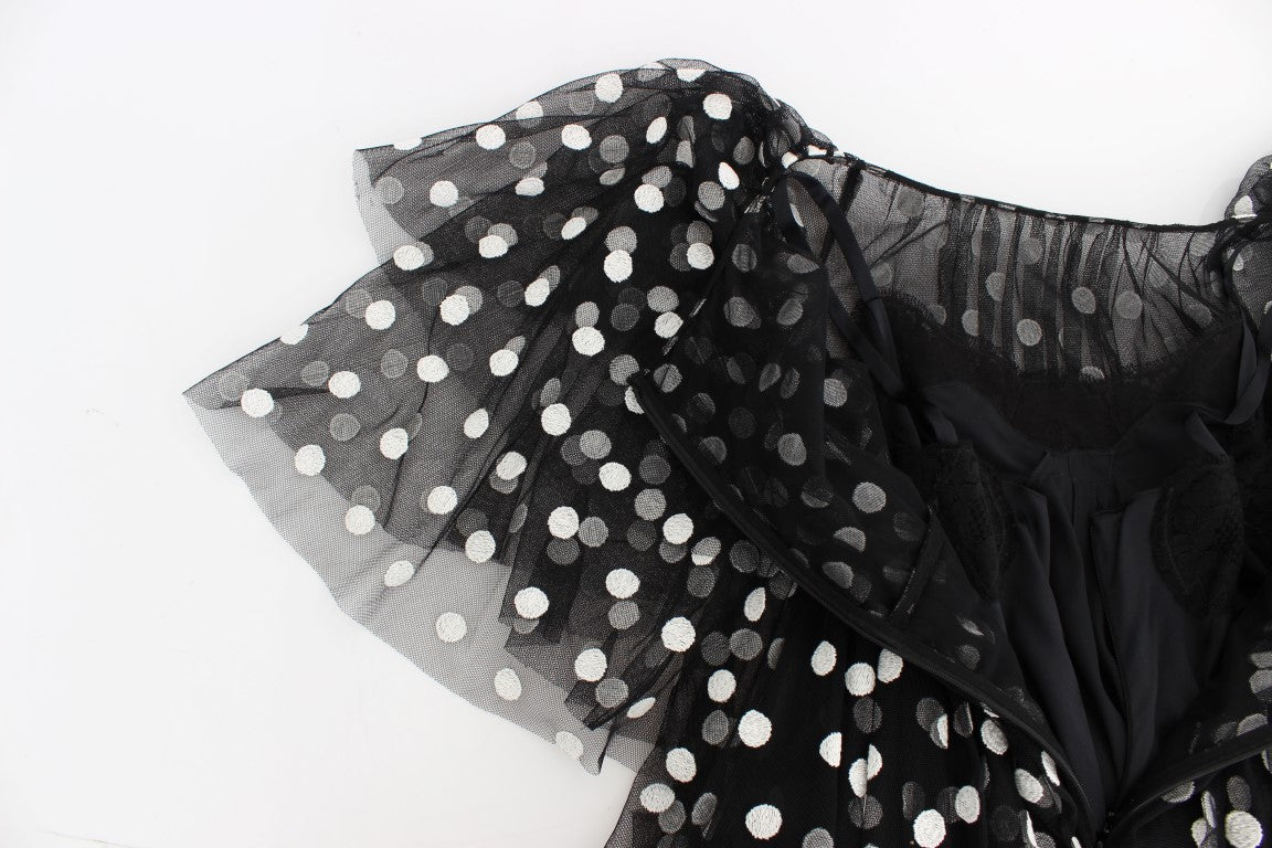 Robe à pois noir et blanc Dolce & Gabbana avec ourlet volant, tissu léger et style élégant, vue de face.