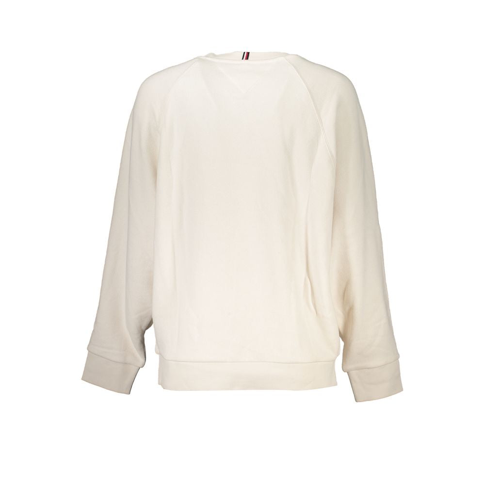 Sweat-shirt beige en coton pour femmes de Tommy Hilfiger, image montrant le style décontracté et le logo discret sur la poitrine.