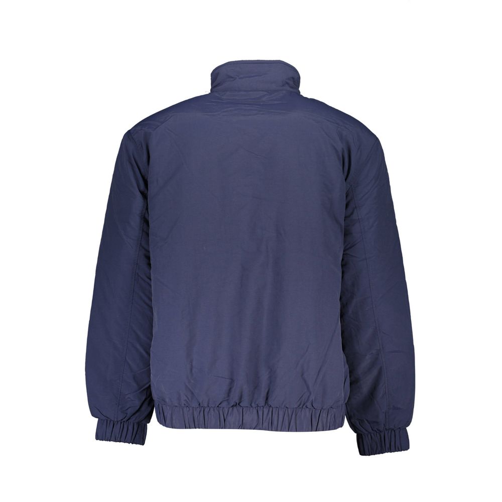 Veste pour homme Tommy Hilfiger en polyamide bleue, coupe ajustée et détails modernes, vue de face.