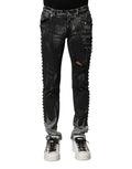 Jeans skinny en denim noir Dolce & Gabbana lavé avec embellissements visibles, coupe ajustée et détails tendance.