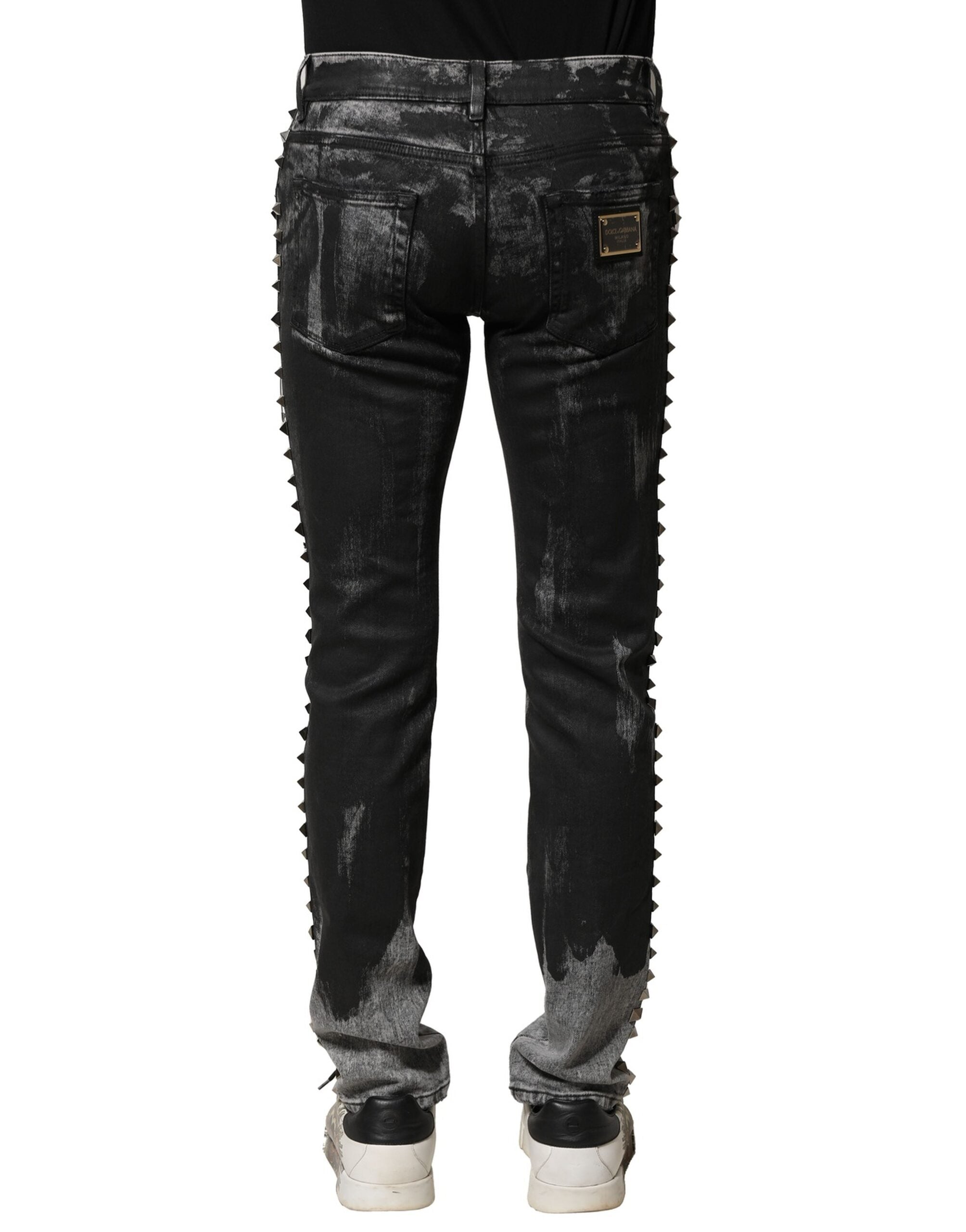 Jean skinny en denim noir Dolce & Gabbana avec délavé et embellissements, style tendance et ajusté.