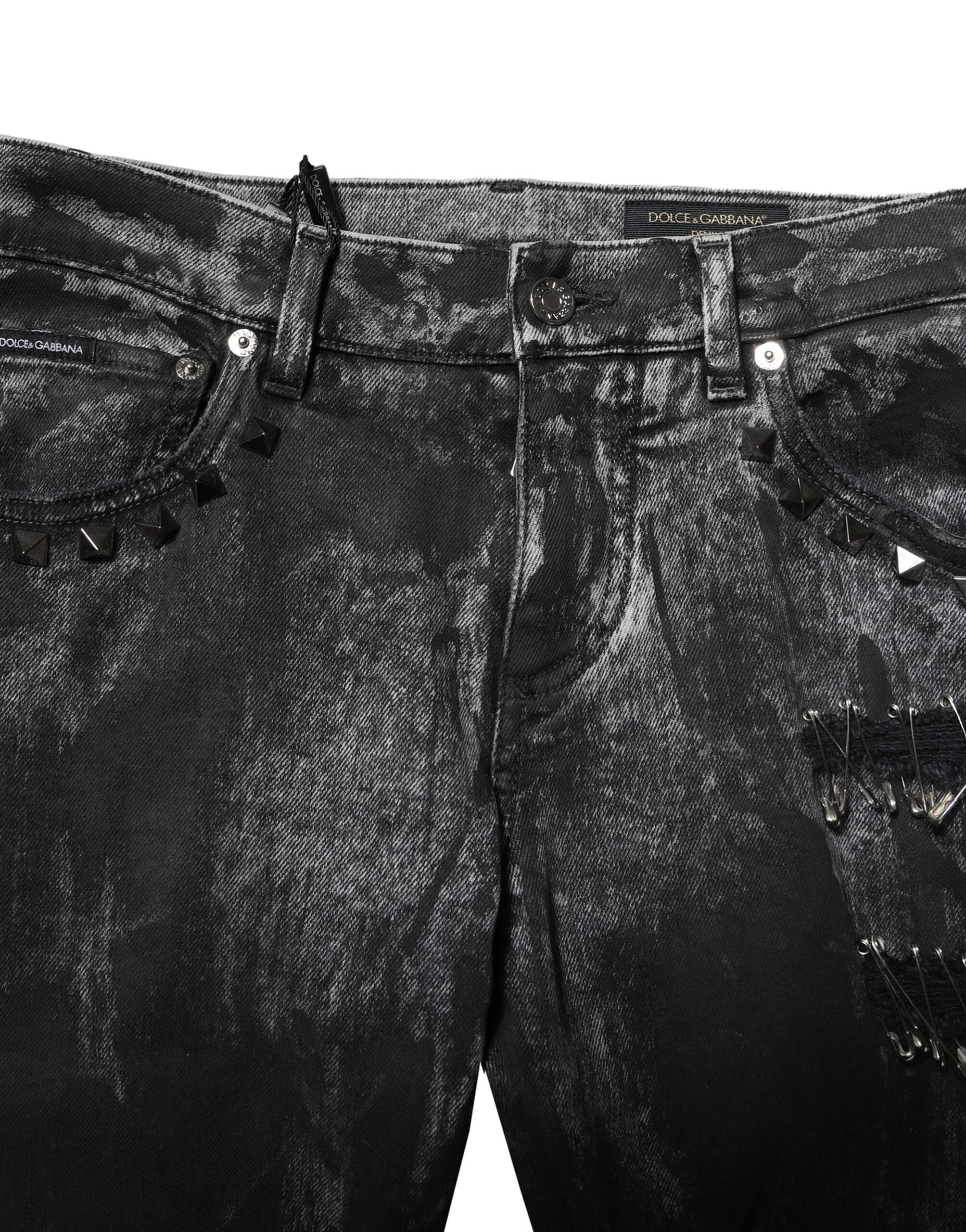Jeans skinny en denim noir Dolce & Gabbana avec délavé et embellissements, visibles avec détails de couture et finition usée.