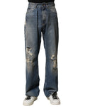 Jeans déchirés en coton bleu pour homme de Dolce & Gabbana, style décontracté avec détails usés.