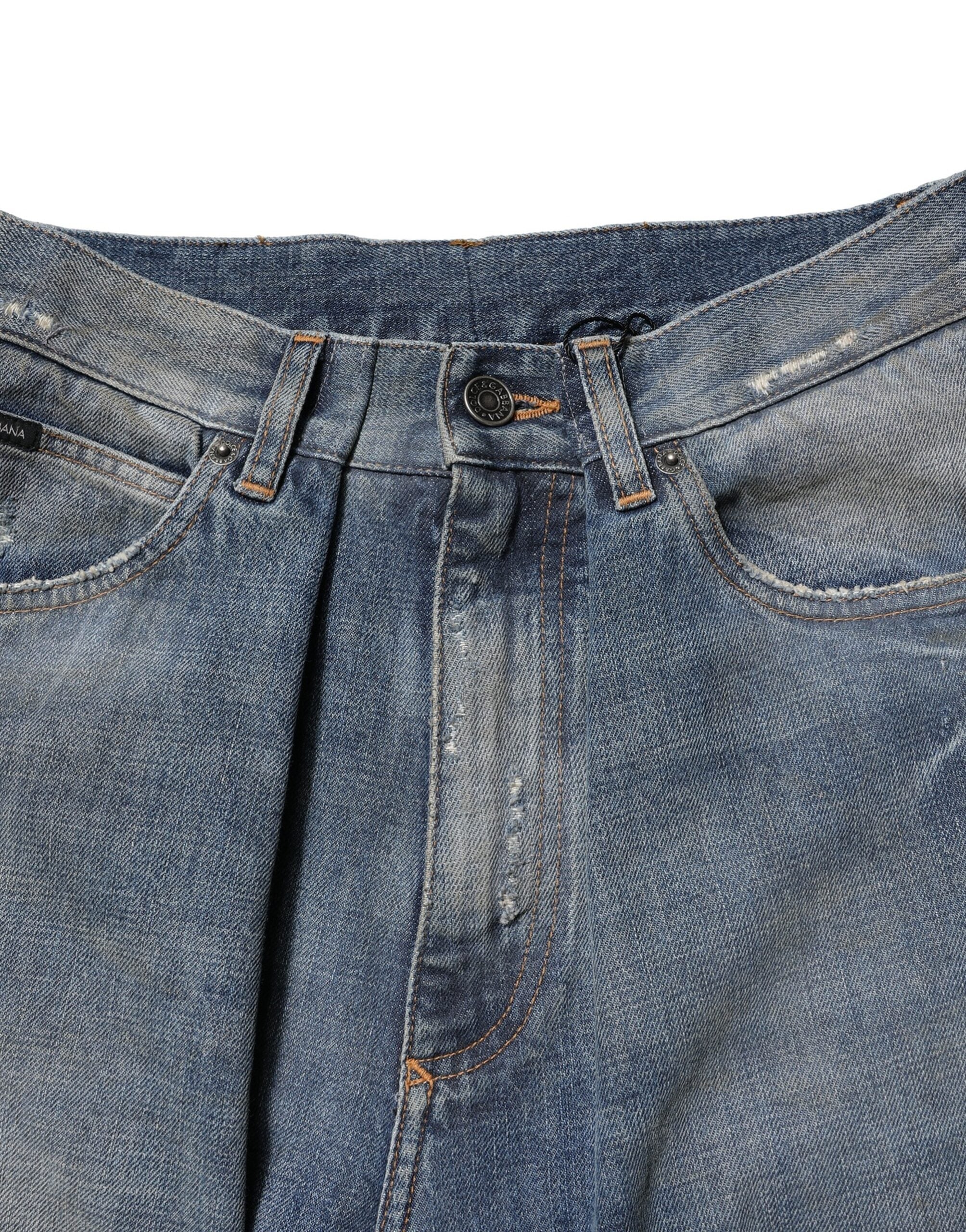 Jean homme en denim bleu Dolce & Gabbana, coton avec déchirures, style décontracté et tendance.