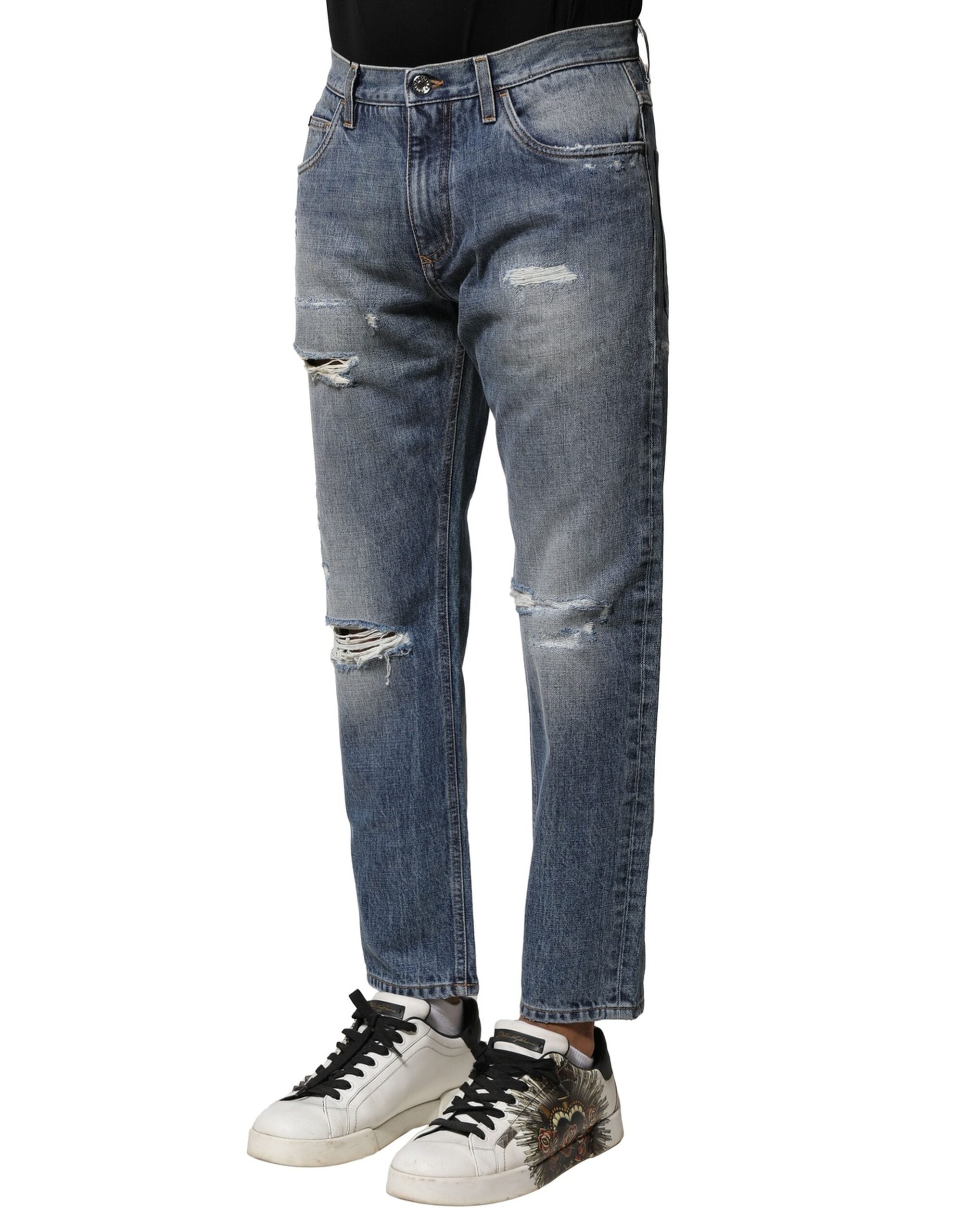 Jeans en jean délavé bleu usé de coupe droite Dolce & Gabbana, style déchiré et tendance, visible en gros plan.
