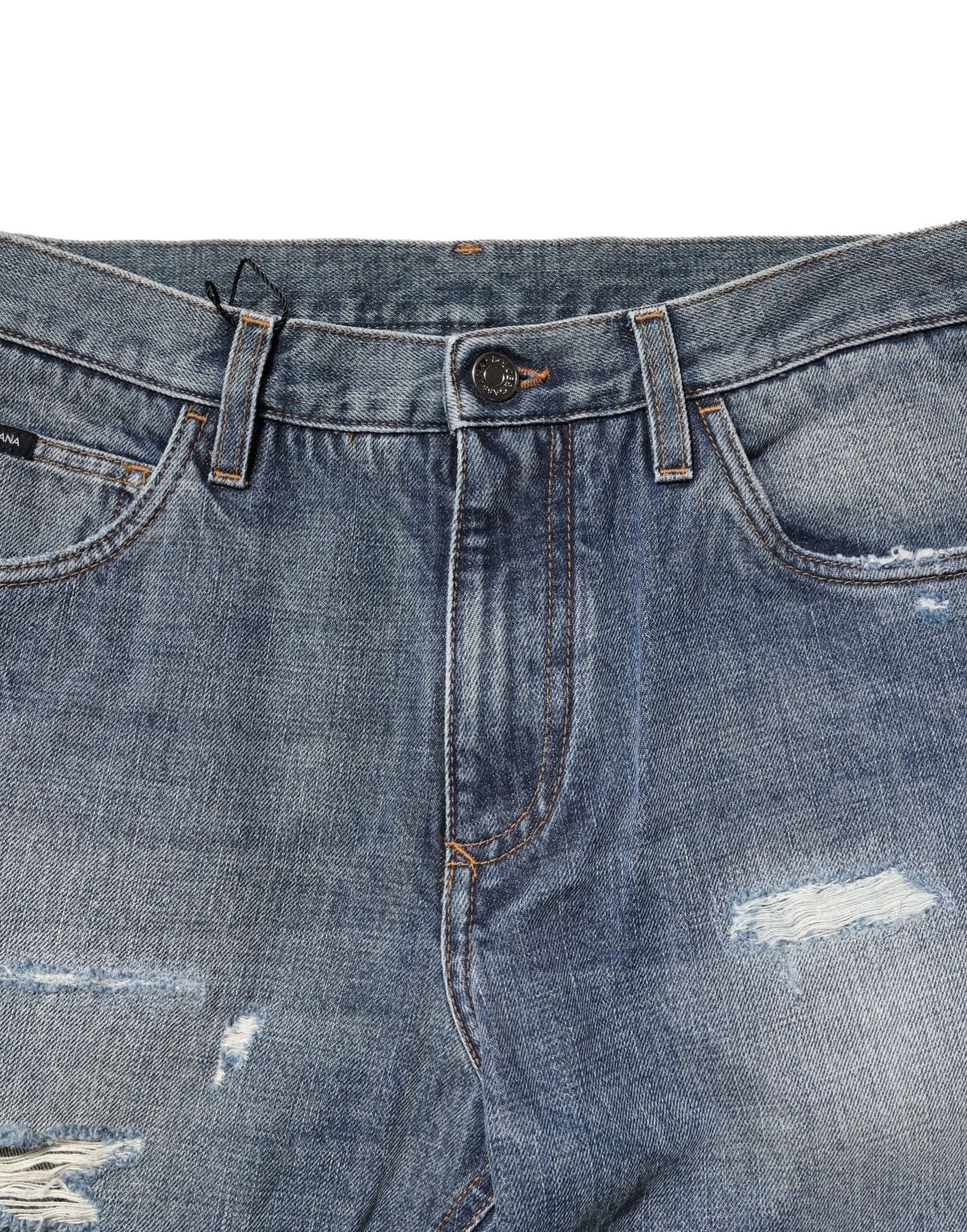 Jeans en denim bleu délavé et déchiré Dolce & Gabbana, coupe droite, style décontracté et tendance.