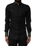 Chemise noire en coton Dolce & Gabbana avec manches longues et détails dorés, élégante et sophistiquée.